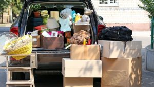 Vehicle packed full of boxes and dorm supplies, boxes sitting all around the vehicle