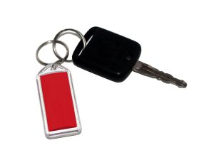 Black and silver key on a red key tag with a white background